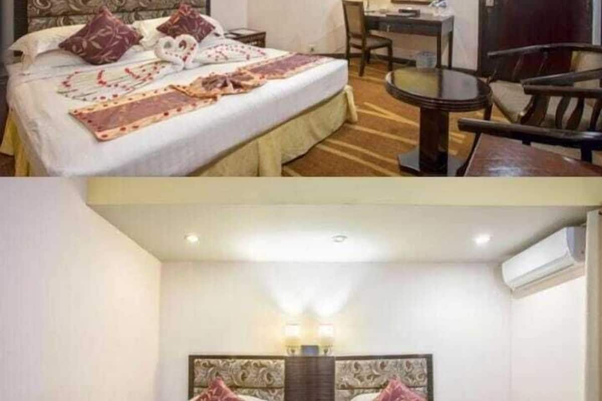 Una habitación de hotel con una cama individual, un escritorio y una silla. La segunda habitación tiene dos camas.