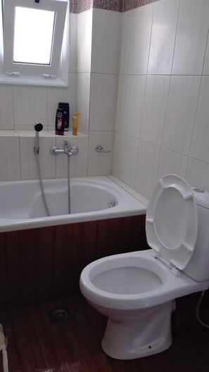 Family Apartment (Split Level) | Bathroom | Bathtub, hair dryer, towels, soap