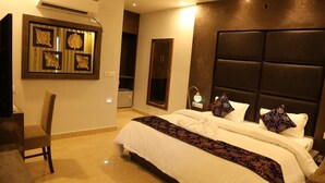 Quarto de hotel com uma cama grande, uma mesa e uma cadeira.
