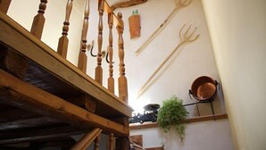 A wooden staircase with a rustic design, a wall-mounted hook, and a hanging plant. - BERLANGA DE DUERO, CAÑÓN DE RÍO LOBOS BURGO DE OSMA, SAN BAUDELIO, (Bayubas de Abajo)