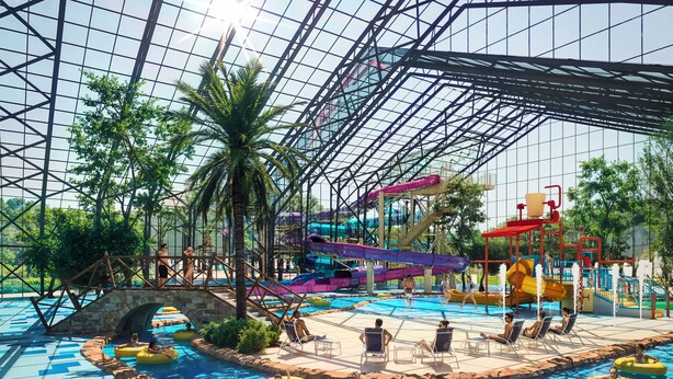 An indoor water park with a large pool, slides, and inflatable tubes.