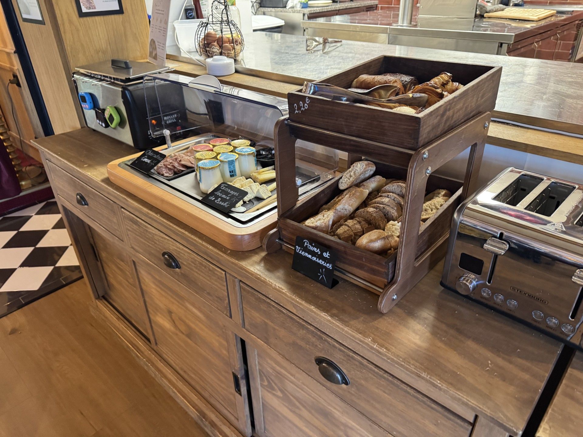 A breakfast buffet with various food items and a coffee machine.