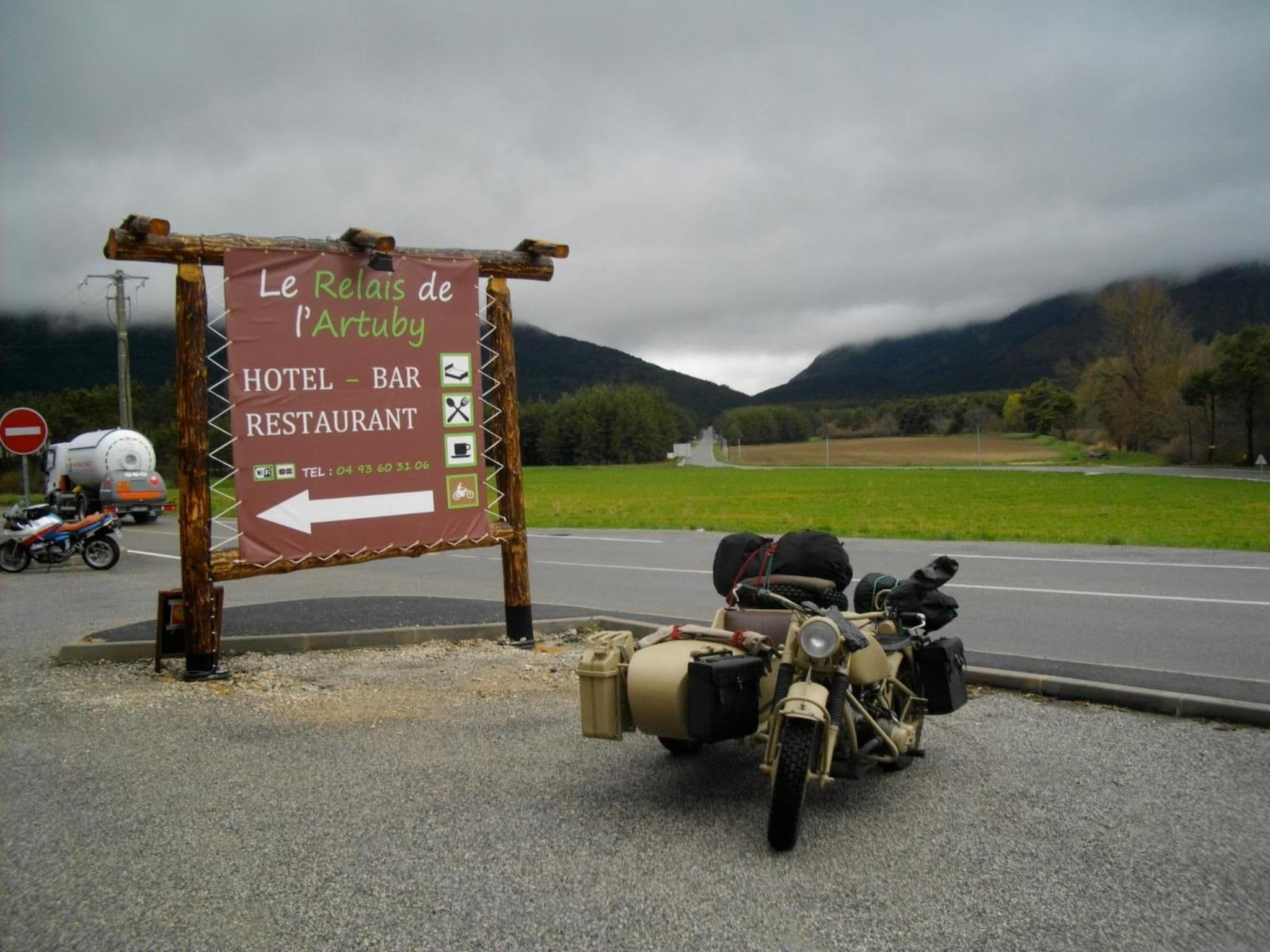 A signboard for Le Relais de l'Artuby, indicating a hotel, bar, and restaurant.