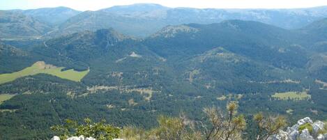 A mountainous landscape with a valley and a lake.