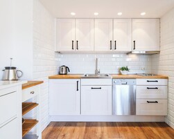 Apartamento família, várias camas | Cozinha americana privada | Geladeira, micro-ondas (mediante solicitação), cooktop, lava-louças
