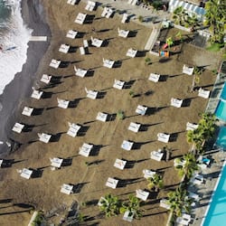 Private beach, black sand, sun-loungers, beach umbrellas