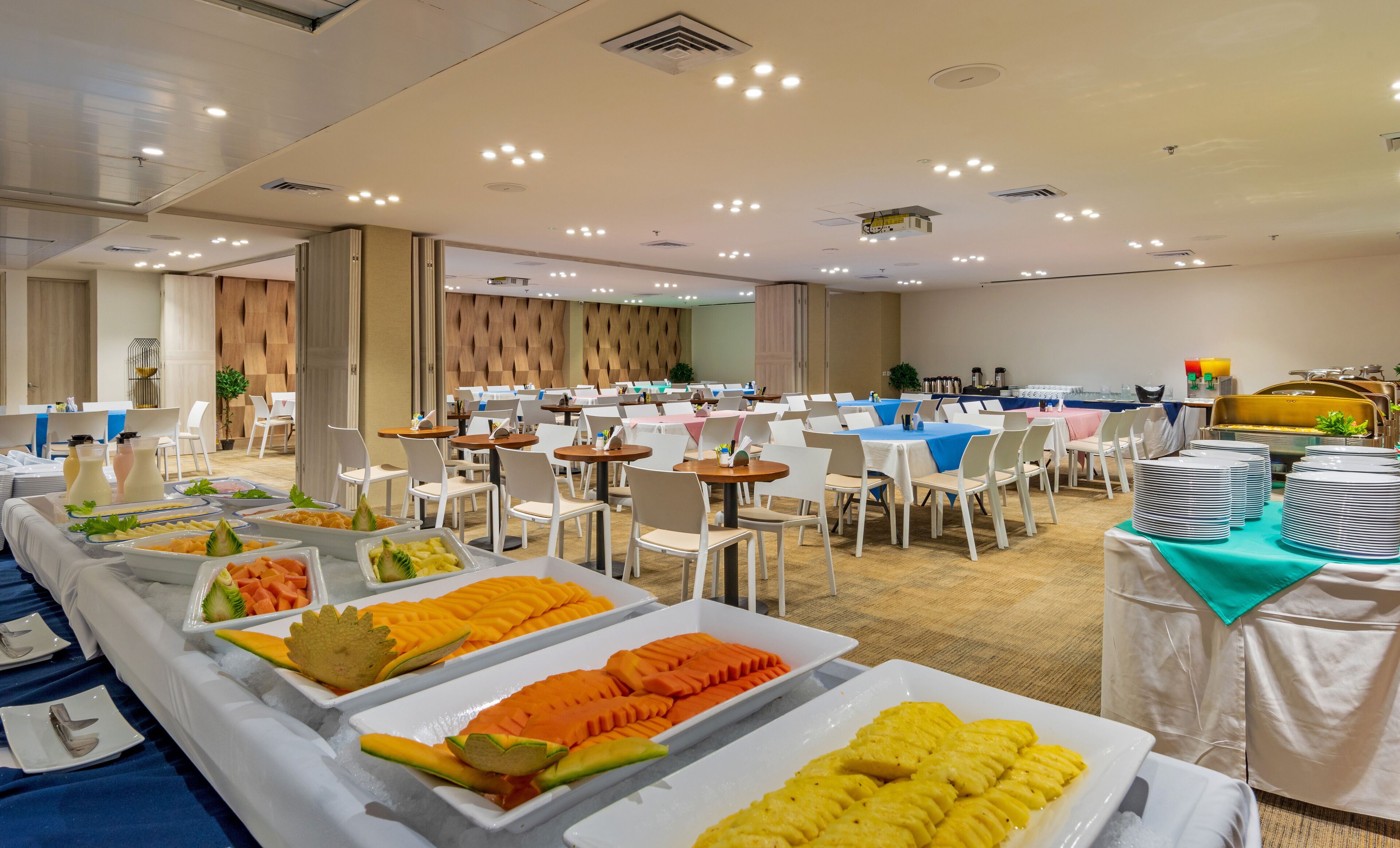A buffet setup with various food items and tables arranged in a spacious room.