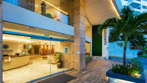 A modern hotel reception with a glass facade, a reception desk, and a well-lit interior. - Samawi (San Andrés)