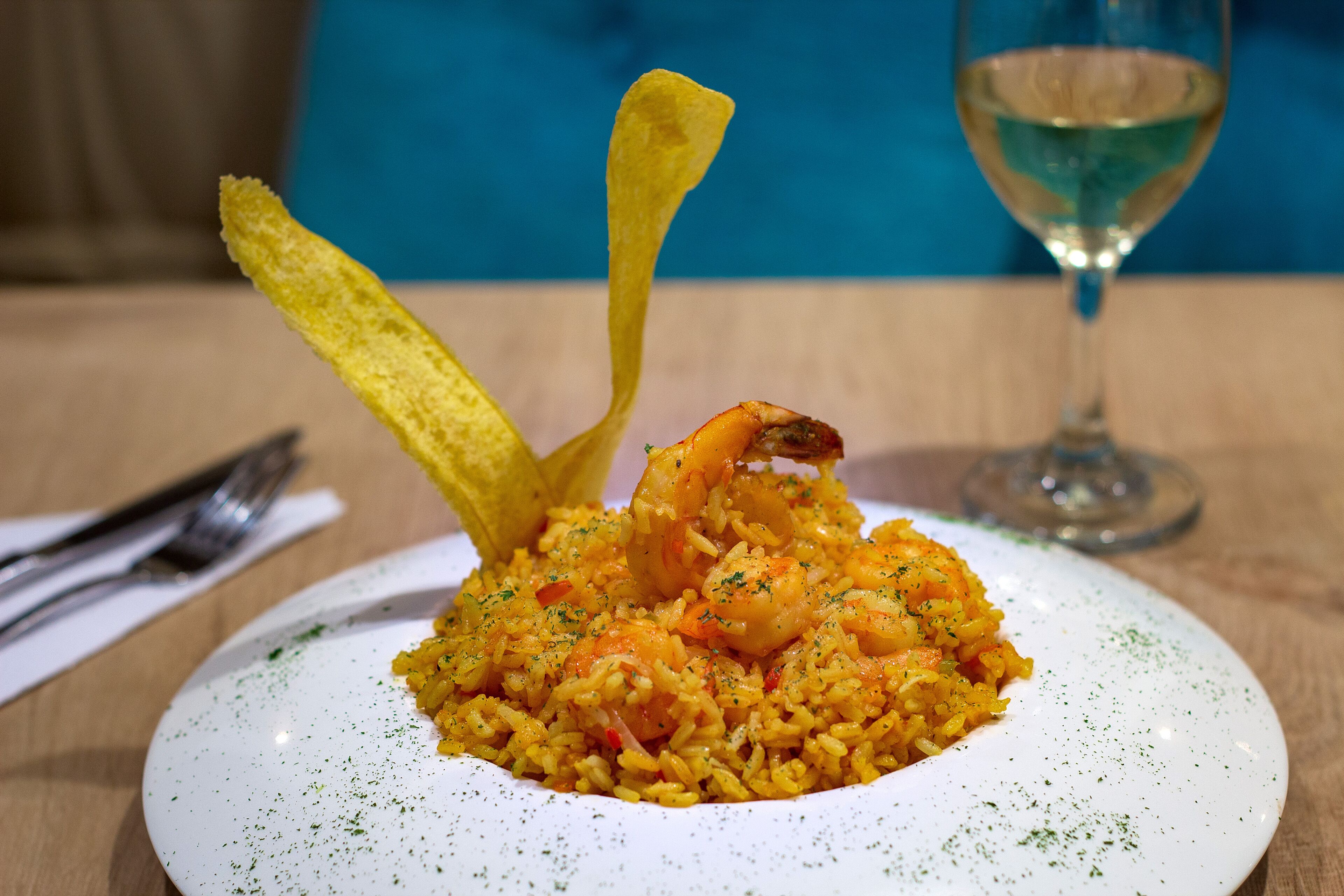 A plate of shrimp and rice with a decorative element.