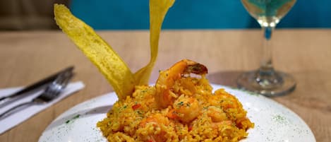 A plate of shrimp and rice with a decorative element.