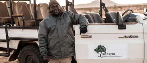 A vehicle with a logo for Toyota Land Cruiser and a sign for Rockfig Madikwe Game Reserve.