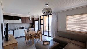 A modern apartment with a dining area, kitchen, and living room. - Blou Inn - Century City (Cape Town)