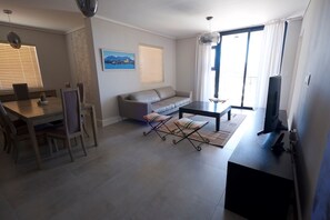 Basic Apartment, 2 Bedrooms | Living area | 50-inch Smart TV with satellite channels, TV