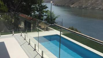 Seasonal outdoor pool, pool umbrellas, pool loungers