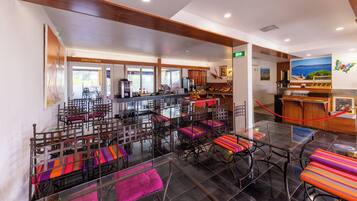 A fitness center with exercise equipment, a reception area, and colorful seating.