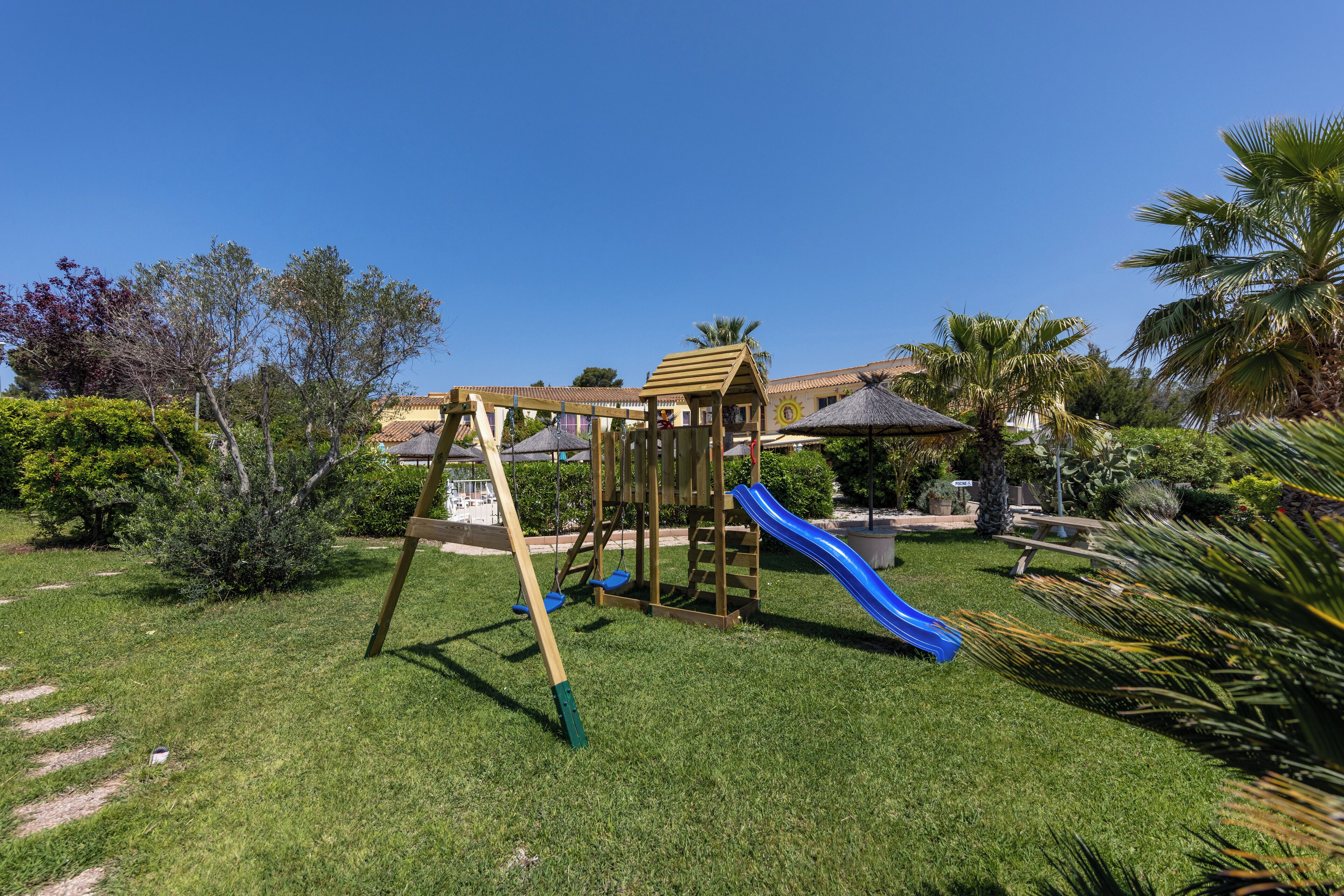 A playground with a slide and climbing structure.