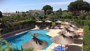 Seasonal outdoor pool, open 10:00 AM to 8:00 PM, pool umbrellas