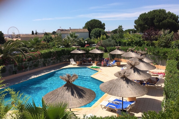 Seasonal outdoor pool, open 10:00 AM to 8:00 PM, pool umbrellas