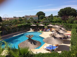 Seasonal outdoor pool, open 10:00 AM to 8:00 PM, pool umbrellas