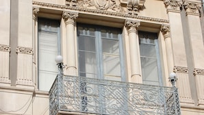 A building with ornate architectural details, including a balcony with decorative railings and columns. - San Demetrio (Catania)