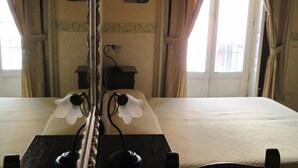 A hotel room with a bed, a mirror, and two wall-mounted lamps. - San Demetrio (Catania)