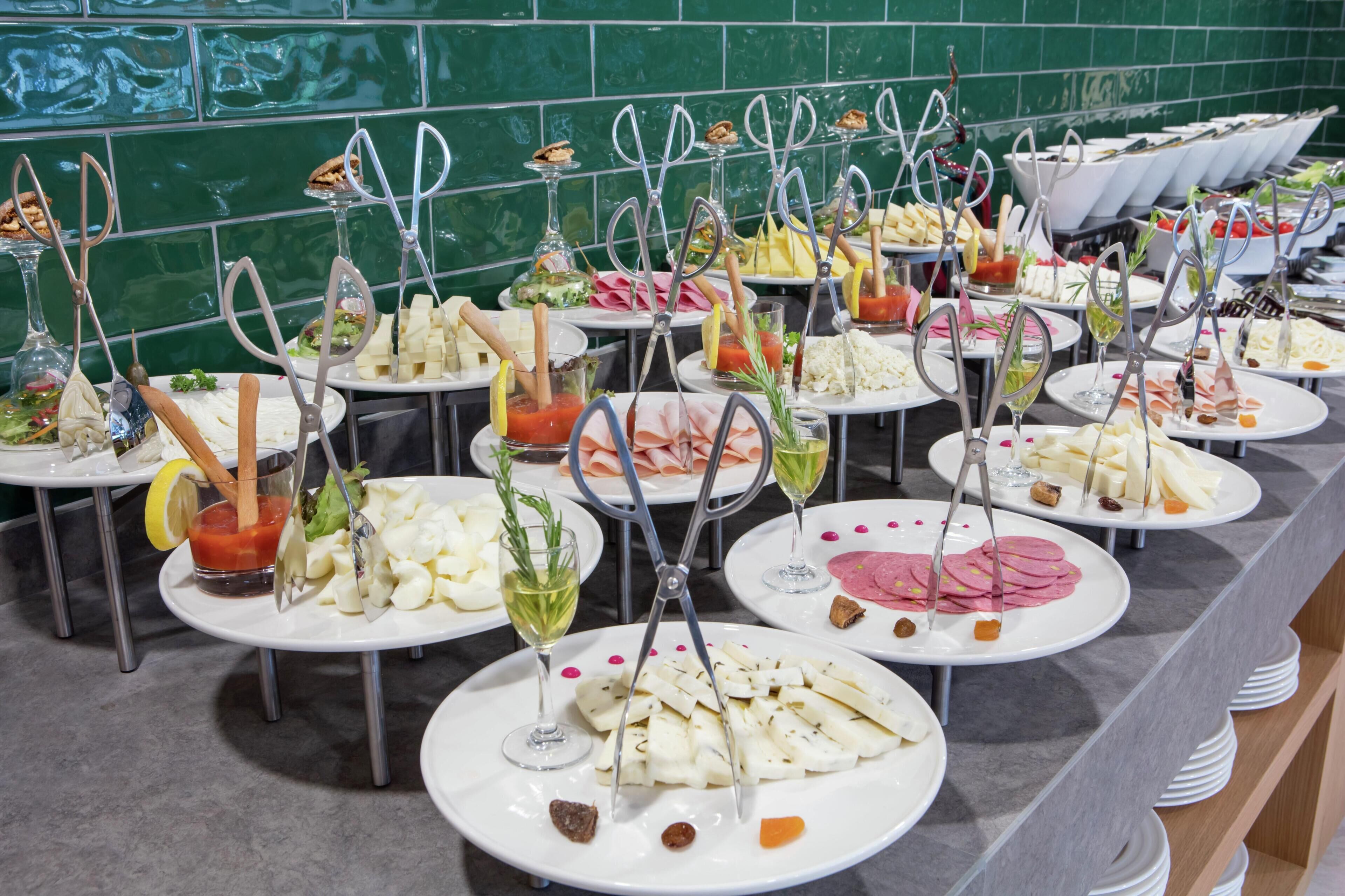 A buffet with various food items and utensils.