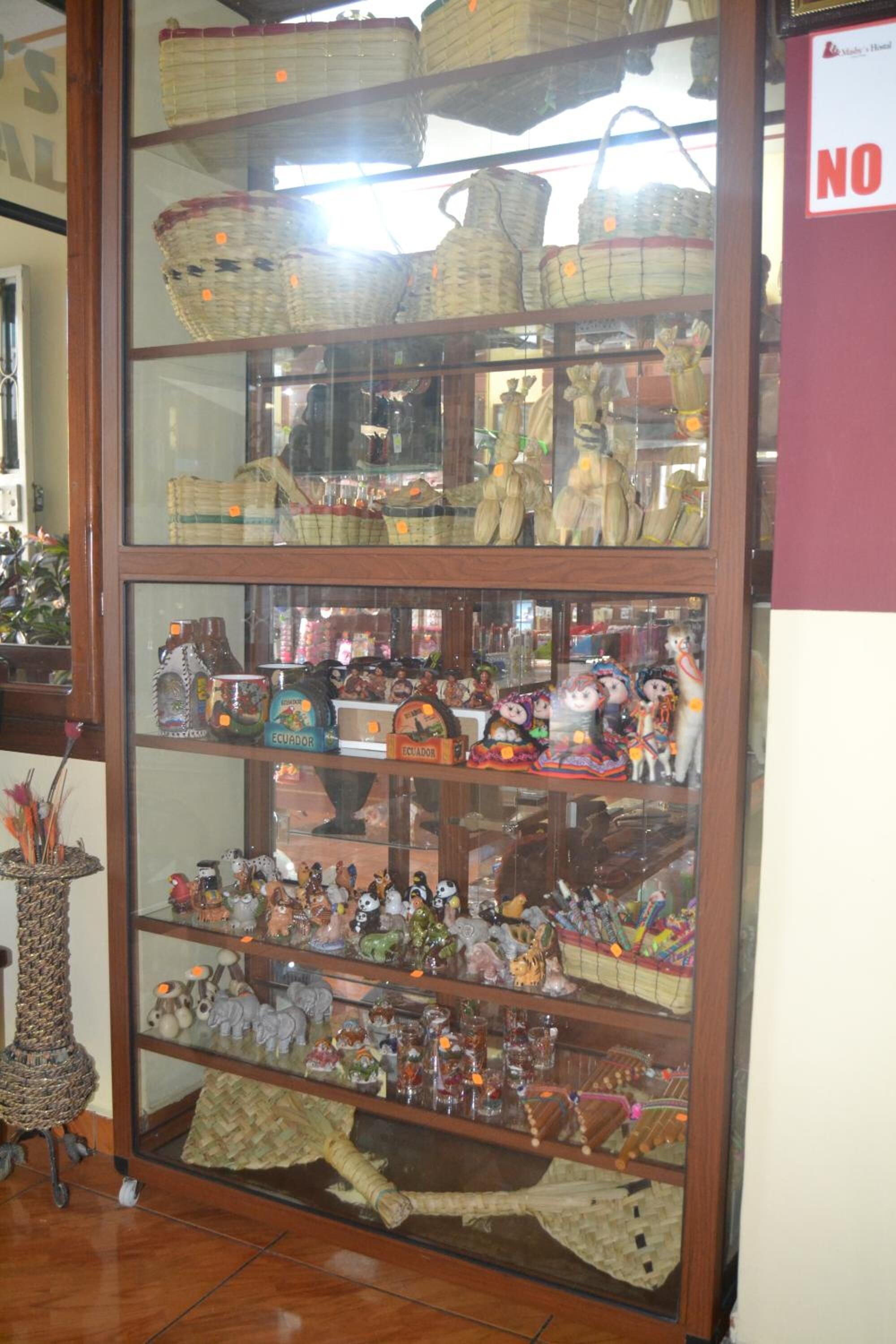 A display case with baskets and figurines.