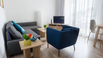 Apartment, 1 Bedroom, Sea View | Living area | 32-inch flat-screen TV with cable channels, TV