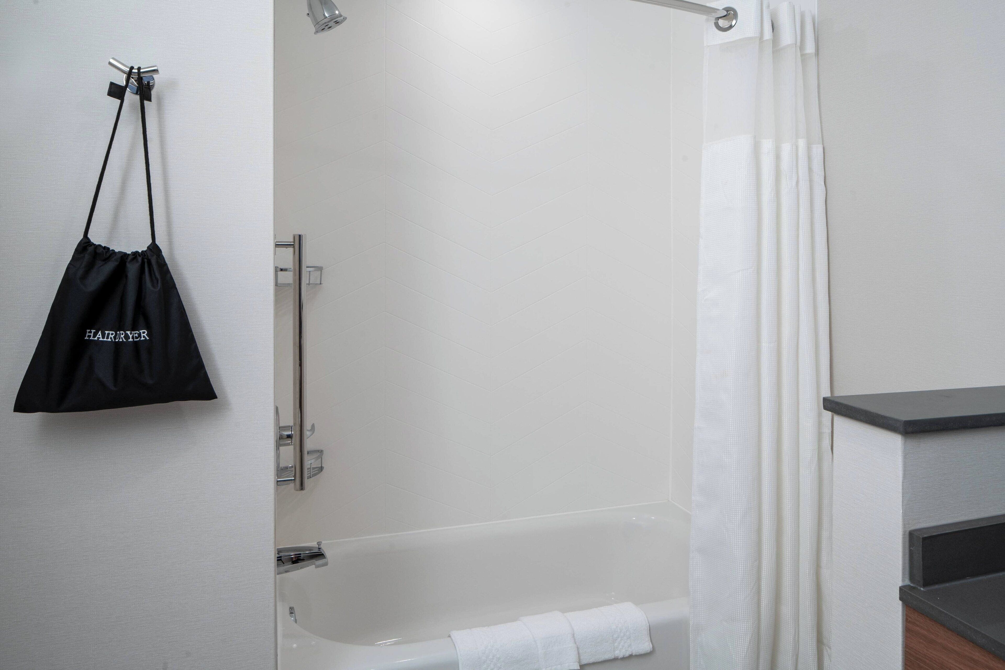 designer toiletries, hair dryer, towels, soap