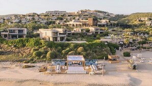 A coastal resort with modern villas, a beach area with lounge chairs, and a clear view of the ocean. - Zadun Los Cabos, a Ritz-Carlton Reserve (San José del Cabo)