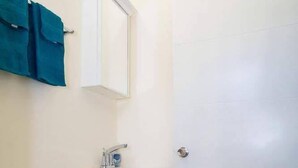 A bathroom with a toilet, sink, and cabinet.
