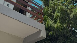A multi-story building with balconies and a clear blue sky. - Hotel Villa Calakmul (Calakmul)
