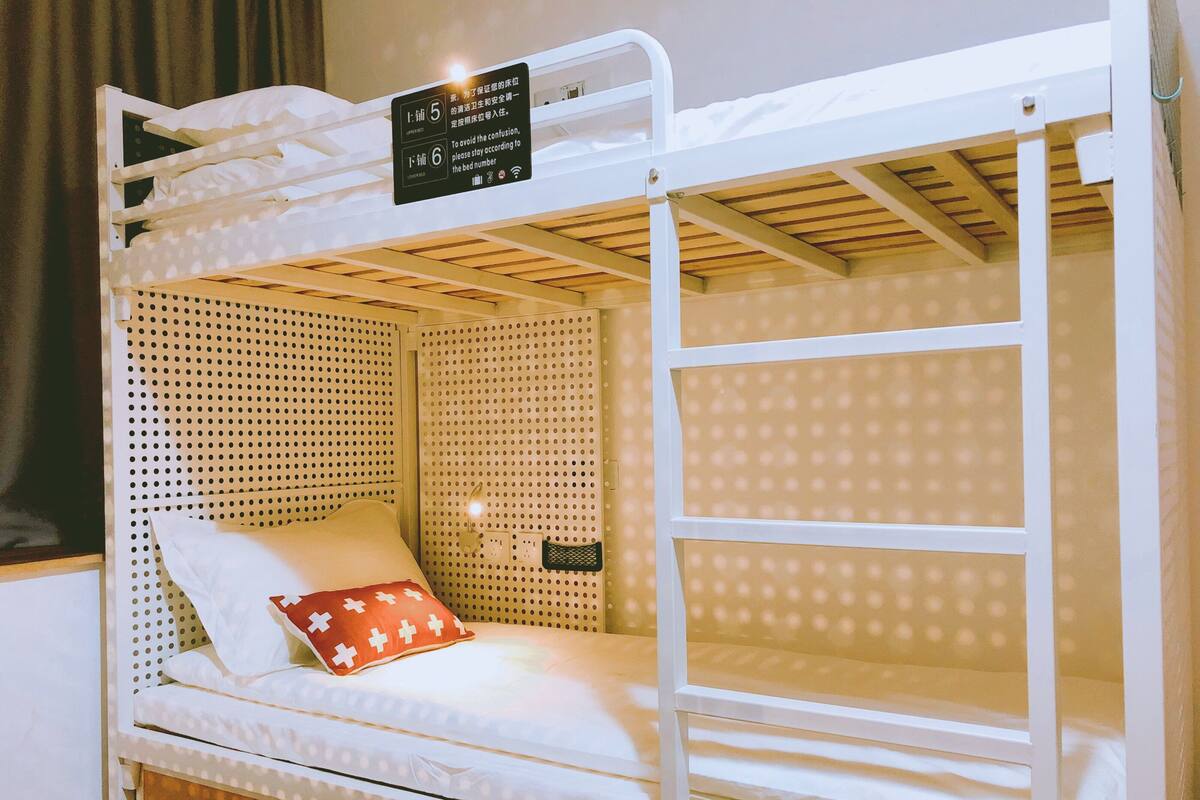 A bunk bed with a sign indicating bed numbers 5 and 6.