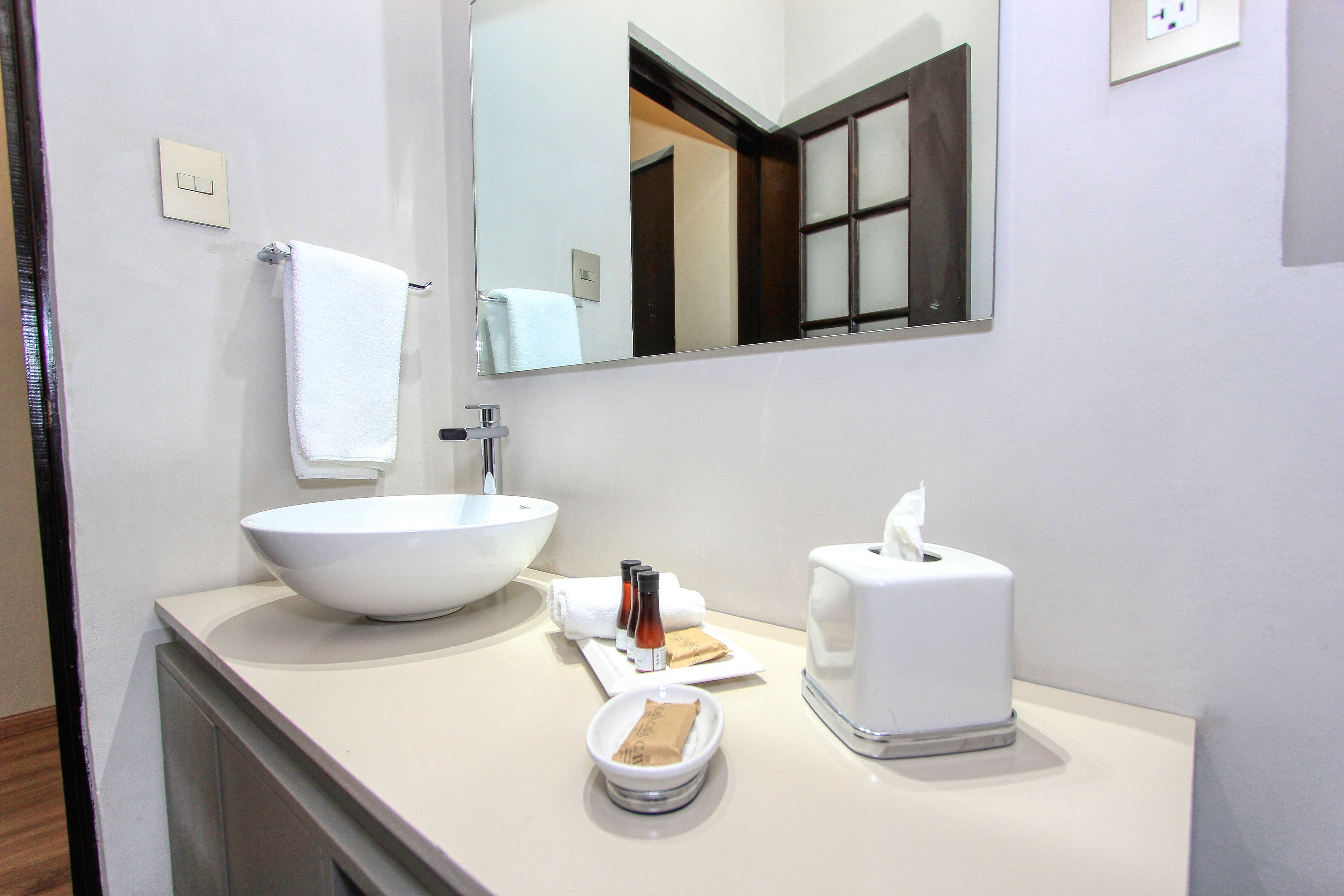 deluxe suite, 1 king bed (romero) | bathroom | free toiletries, hair dryer, bathrobes, slippers