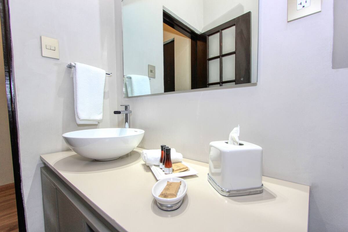deluxe suite, 1 king bed (romero) | bathroom | free toiletries, hair dryer, bathrobes, slippers