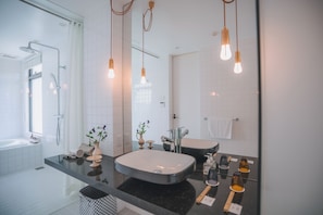 A modern bathroom with a large mirror, two sinks, a shower, and pendant lights. - BLUE STEAK WONDER SENAHA (Yomitan)
