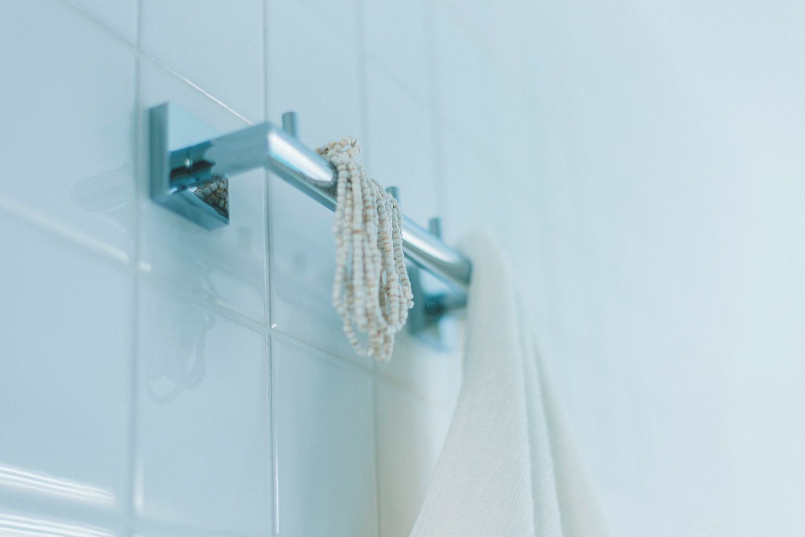 A bathroom with a towel rack and a hanging towel.