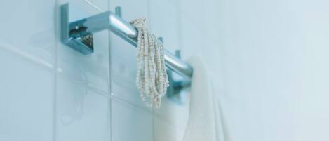 A bathroom with a towel rack and a hanging towel.