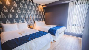 A hotel room with two beds, a patterned wall, a window with blinds, and a wooden floor. - BLUE STEAK WONDER SENAHA (Yomitan)