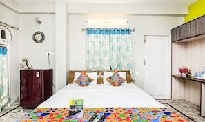 A bedroom with a bed, a wardrobe, a clock, and a window with curtains. - FabHotel Transit Guest House (Barasat)