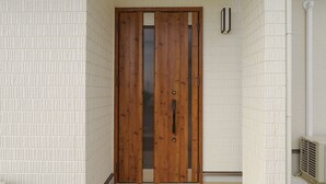 A wooden door with a handle and a glass panel, set in a hallway with white textured walls and a white radiator. - Hyakuna Terrace (Nanjo)