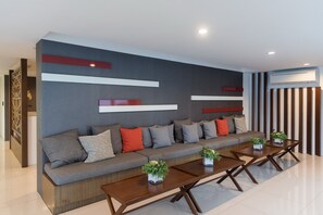 A modern living room with a sofa, coffee tables, and decorative elements. - Baan Kunkoey & KuKeange by Passionata (Hua Hin)
