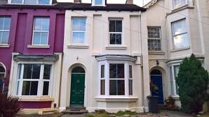 A row of terraced houses with distinct front doors and windows. - Regent Serviced Suites (Doncaster)