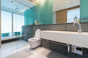 A modern bathroom with a glass-enclosed shower, a white toilet, and a large sink. - Hua Hin Luxury Condo by Passionata (Hua Hin)