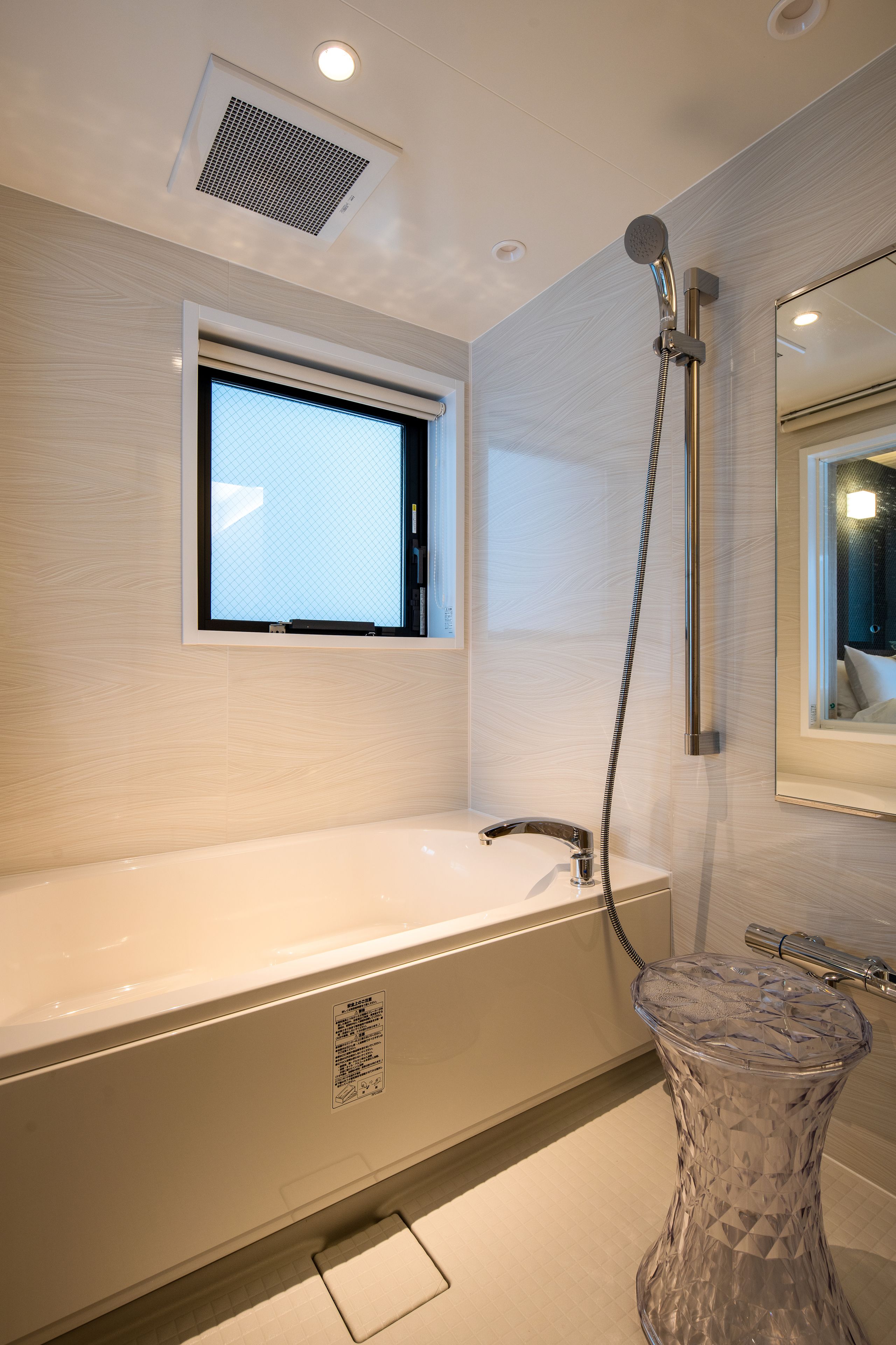 A modern bathroom with a bathtub, a shower, and a glass pedestal sink.