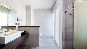 A modern bathroom with a large sink, mirror, and shower area. - Brother B&B (Magong)