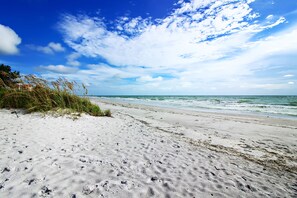 A beach with a clear sky and ocean waves.