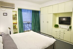 Four-Bedroom Apartment | Desk, blackout drapes, iron/ironing board, free WiFi