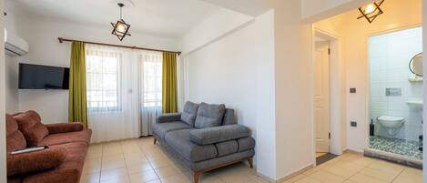 Apartment, 1 Bedroom, Garden Area | Individually decorated, desk, laptop workspace, blackout drapes