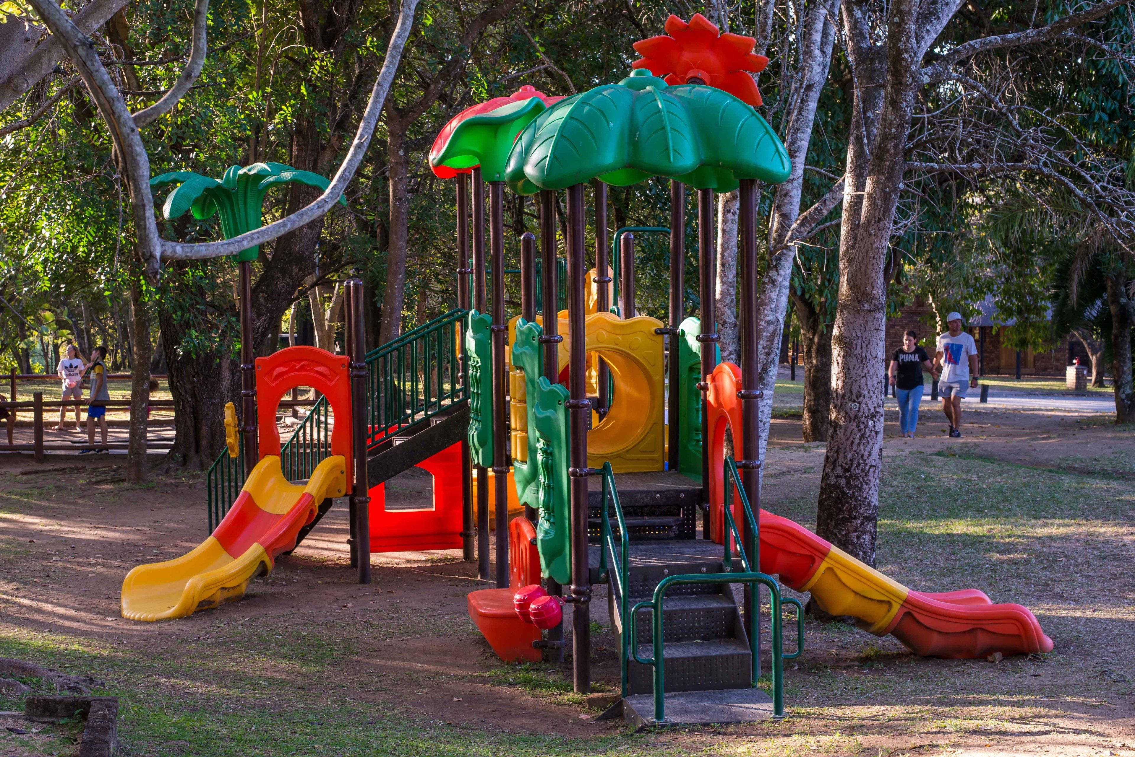A playground with multiple slides and climbing structures.